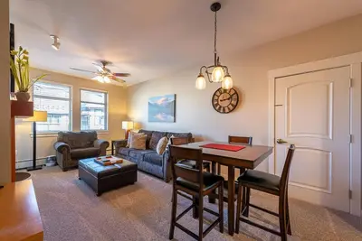 a living room with a table and a couch at Ski-In / Ski-Out 1 Bedroom Condo base of WP Resort in Winter Park