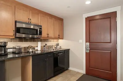 a kitchen with a sink and a microwave at Ski-In / Ski-Out 1 Bedroom Condo base of WP Resort in Winter Park