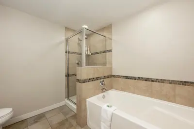 a bathroom with a tub and a toilet at Ski-In / Ski-Out 1 Bedroom Condo base of WP Resort in Winter Park