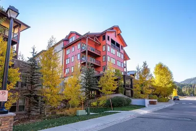 a large red building on the side of a street at Ski-In / Ski-Out Studio Condo at the base of Winter Park in Winter Park