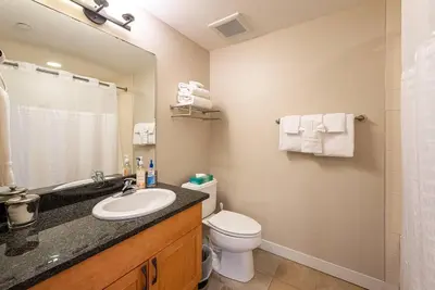 a bathroom with a sink and a toilet and a mirror at Ski-In / Ski-Out Studio Condo at the base of Winter Park in Winter Park