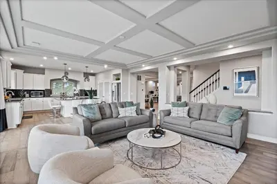 a living room with two couches and a table at The Retreat at Buffalo Run Golf Course - Commerce City in Henderson