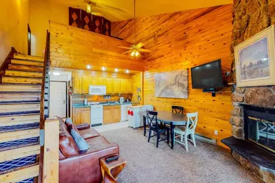 a living room with a couch and a table at Silver Lodge B in Granby