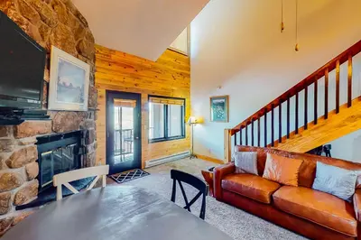a living room with a couch and a fireplace at Silver Lodge B in Granby