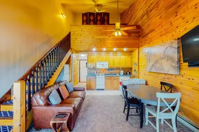 a living room with a couch and a table at Silver Lodge A & B in Granby