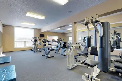 a gym with treadmills and machines in a room at Silver Lodge A & B in Granby