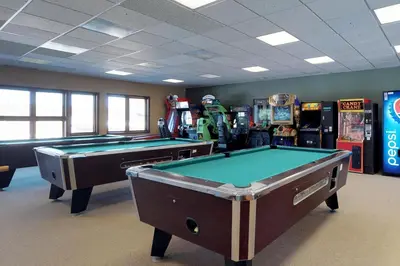 two pool tables in a room with arcade machines at Silver Lodge A in Granby