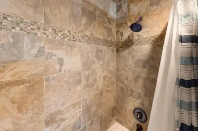a bathroom with a shower with a shower curtain at Silver Lodge A in Granby