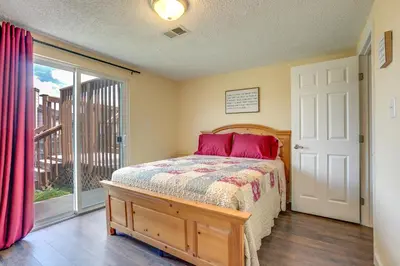 a bedroom with a bed and a large window at Grill, Fireplace and Fenced-In Yard Thornton Home! in Thornton