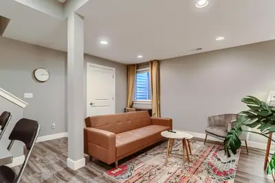 a living room with a couch and a table at Central Park - 28th Place Apt in Aurora