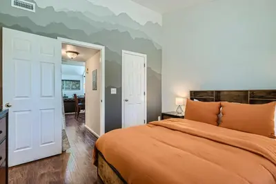a bedroom with a bed with an orange blanket at 4044 S Carson St Unit B - Aurora in Aurora