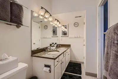 a white bathroom with a sink and a mirror at 4044 S Carson St Unit B - Aurora in Aurora