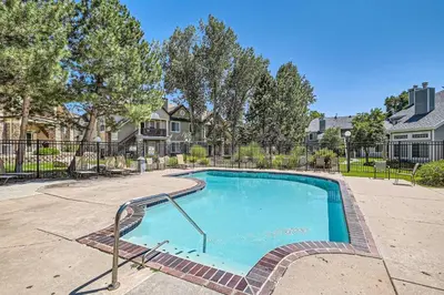 a swimming pool in a yard with trees and houses at 4044 S Carson St Unit B - Aurora in Aurora