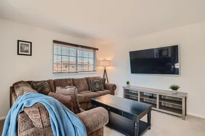 a living room with a couch and a table at 4044 S Carson St Unit B - Aurora in Aurora