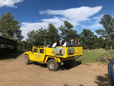 a group of people riding in the back of a yellow truck at Aspen Suite - Hot Tub, Minutes to RMNP, Walking Distance to Mary's Lake in Estes Park