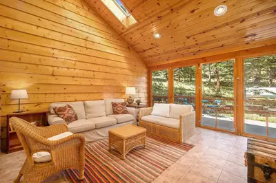 a living room with a couch and chairs in a cabin at Kittery West - Monthly Long-Term Vacation Rental Only home in Estes Park