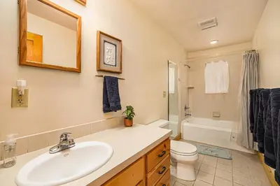 a bathroom with a sink and a toilet and a tub at Kittery West - Monthly Long-Term Vacation Rental Only home in Estes Park