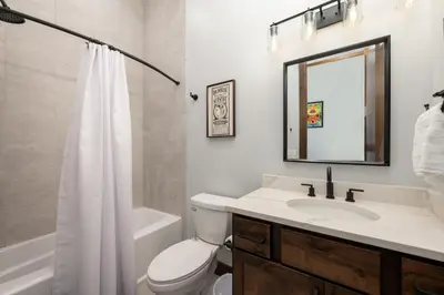 a bathroom with a sink and a toilet and a mirror at Hay Meadow Lodge townhouse in Fraser