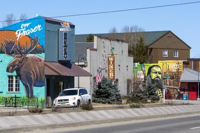 a car parked in front of a building with a mural at Hay Meadow Lodge townhouse in Fraser