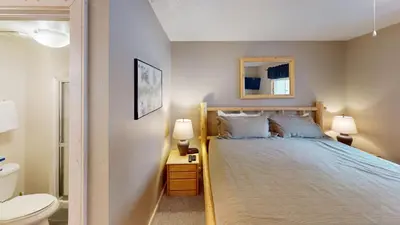 a bedroom with a bed and a toilet and a mirror at B104 Snowdance Condos condo in Keystone