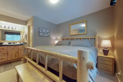a bedroom with a bed with a wooden frame at B104 Snowdance Condos condo in Keystone