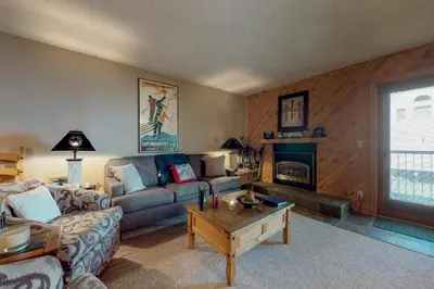 a living room with a couch and a fireplace at B104 Snowdance Condos condo in Keystone