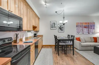 a kitchen and living room with a table and a couch at Ski-InandSki-Out, Scenic Mtn Views Granby Retreat! in Granby