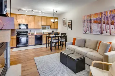 a living room and kitchen with a couch and a table at Ski-InandSki-Out, Scenic Mtn Views Granby Retreat! in Granby