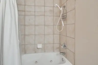 a bathroom with a tub and a shower curtain at Ski-InandSki-Out, Scenic Mtn Views Granby Retreat! in Granby