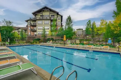 a swimming pool in front of a large building at Ski-InandSki-Out, Scenic Mtn Views Granby Retreat! in Granby