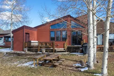 a red house with a picnic table in front of it at 701B Quail in Fraser