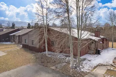 a house with trees in front of it at 701B Quail in Fraser