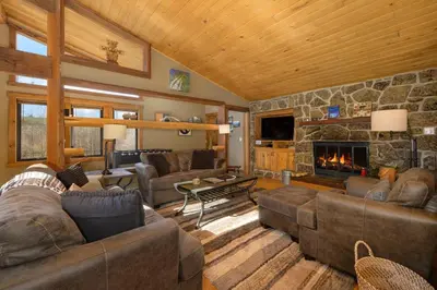 a living room with couches and a stone fireplace at 701B Quail in Fraser