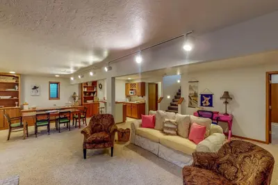 a living room with a couch and a dining room at Work and Play! Spacious Lake-View Home in Greeley in Greeley