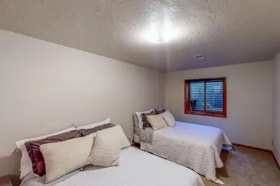 a bedroom with two beds and a window at Work and Play! Spacious Lake-View Home in Greeley in Greeley