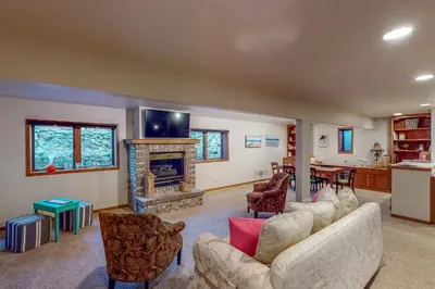 a living room with two couches and a fireplace at Work and Play! Spacious Lake-View Home in Greeley in Greeley