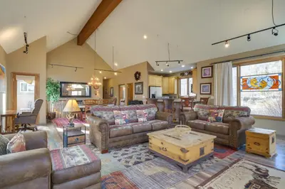 a large living room with couches and a table at 1 Mi to Keystone Lifts Hot Tub Haven with Mtn Views in Keystone