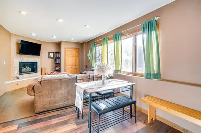 a living room with a couch and a table at 1 Mi to Keystone Lifts Hot Tub Haven with Mtn Views in Keystone