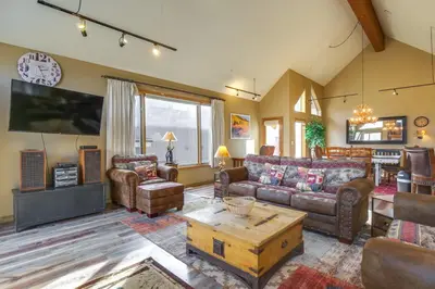 a living room with a couch and a table at 1 Mi to Keystone Lifts Hot Tub Haven with Mtn Views in Keystone