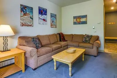 a living room with a couch and a coffee table at Walk to Ski Lifts Townhome with Hot Tub in Keystone in Keystone