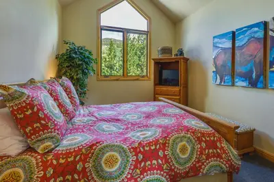 a bedroom with a bed and a window at Walk to Ski Lifts Townhome with Hot Tub in Keystone in Keystone