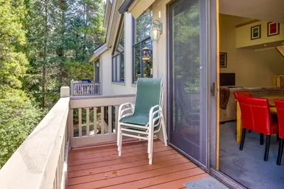 a porch with a chair and a table at Walk to Ski Lifts Townhome with Hot Tub in Keystone in Keystone