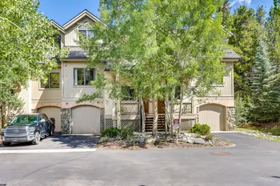 a house with a car parked in front of it at Walk to Ski Lifts Townhome with Hot Tub in Keystone in Keystone