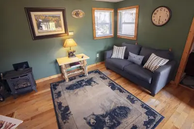 a living room with a couch and a table at Lazy R Cottages- 4 cabin in Estes Park