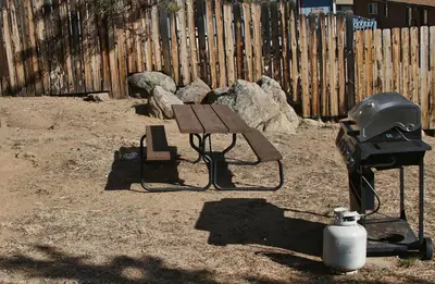 a helmet and a picnic table and a grill at Lazy R Cottages- 4 cabin in Estes Park