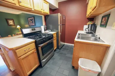 a small kitchen with a stove and a sink at Fawn Valley Inn- 297 condo in Estes Park