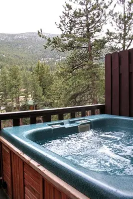 a hot tub on a balcony with a view at Fawn Valley Inn- 297 condo in Estes Park