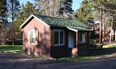 a small shed sitting on the side of a road at Triple R Cottages- 6 cabin in Estes Park