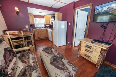a kitchen with purple walls and a white refrigerator at Triple R Cottages- 6 cabin in Estes Park