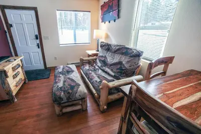 a living room with two chairs and a table at Triple R Cottages- 6 cabin in Estes Park